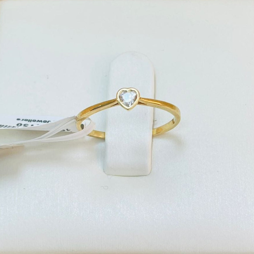 Gold ring with heart detail on a white box with product details.