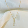 Gold chain necklace on a white fabric background