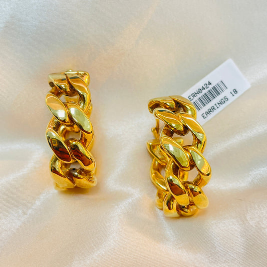 Pair of gold chain earrings on a white fabric background with a visible tag.